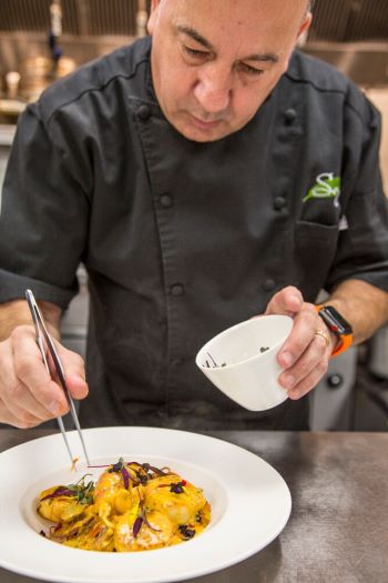 Chef Christopher Covelli finishes dish