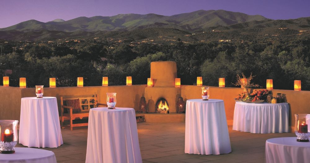 Outdoor dining facilities set with tables with mountains in background