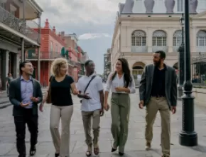 Group of attendees walking down a street in New Orleans